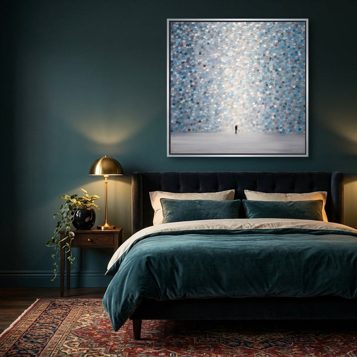 Canvas wall art with a silver leaf surround styled on the wall in a moody bedroom