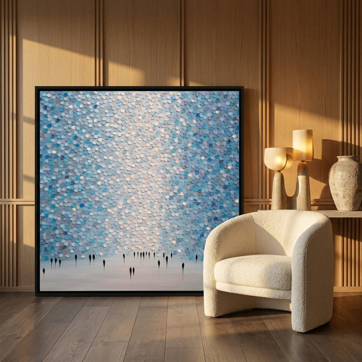 Oversized statement canvas wall art with a black surround leaning against the wall in a luxe dining room