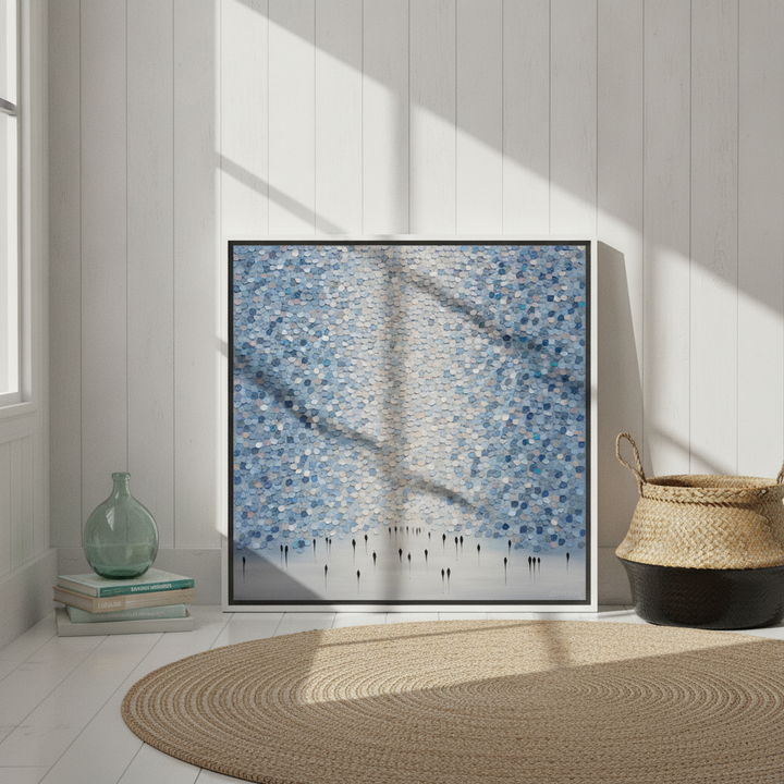 Canvas wall art with a white surround leaning against the wall in a coastal home office