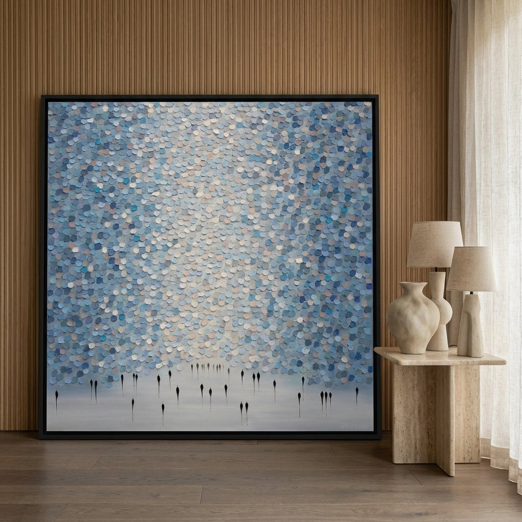 Oversized statement canvas wall art with a black surround leaning against the wall in a luxe living room
