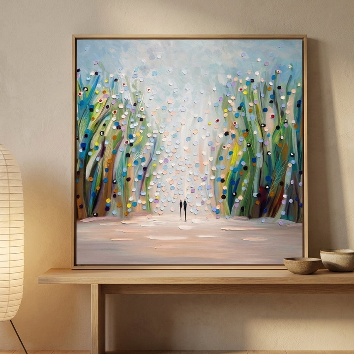Canvas wall art with a natural timber surround standing on a bench in a warm Japandi bedroom