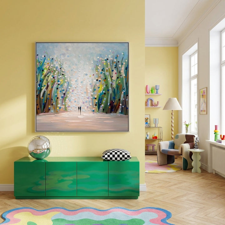Oversized statement canvas wall art with a silver leaf surround styled on the wall in a colourful eclectic living room