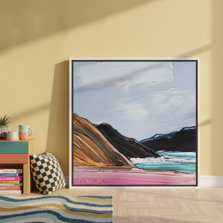 Canvas wall art with a white surround leaning against the wall in a colourful eclectic home office