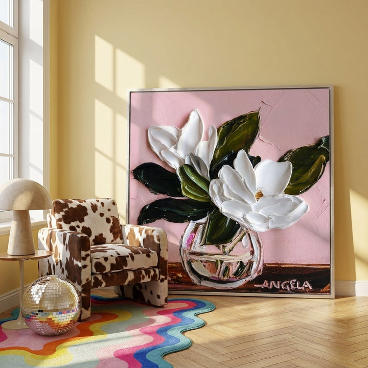 Canvas wall art with a silver leaf surround leaning against the wall in a colourful eclectic bedroom