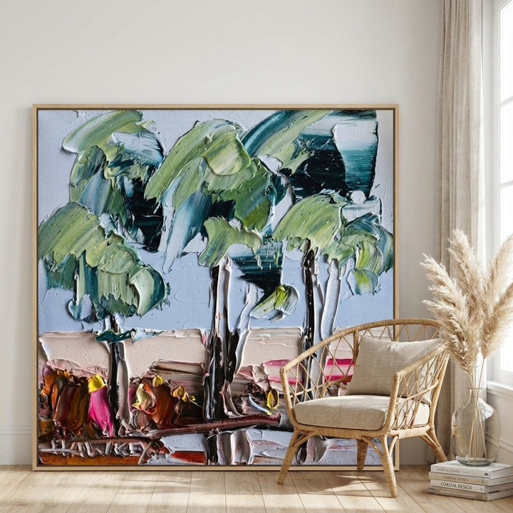 Oversized statement canvas wall art with a natural timber surround leaning against the wall in a coastal dining room