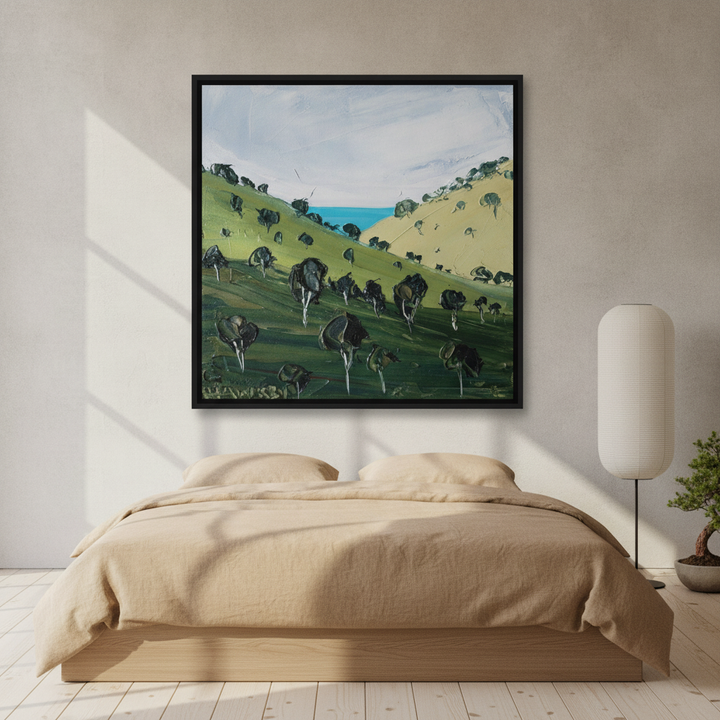 Canvas wall art with a black surround styled on the wall in a warm Japandi bedroom