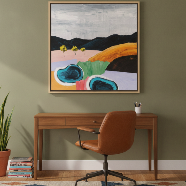 Canvas wall art with a natural timber surround styled on the wall in a mid-century home office