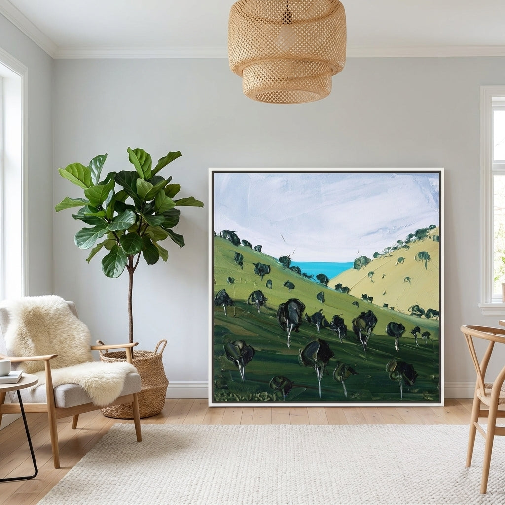 Oversized statement canvas wall art with a white surround leaning against the wall in a bright Scandinavian dining room