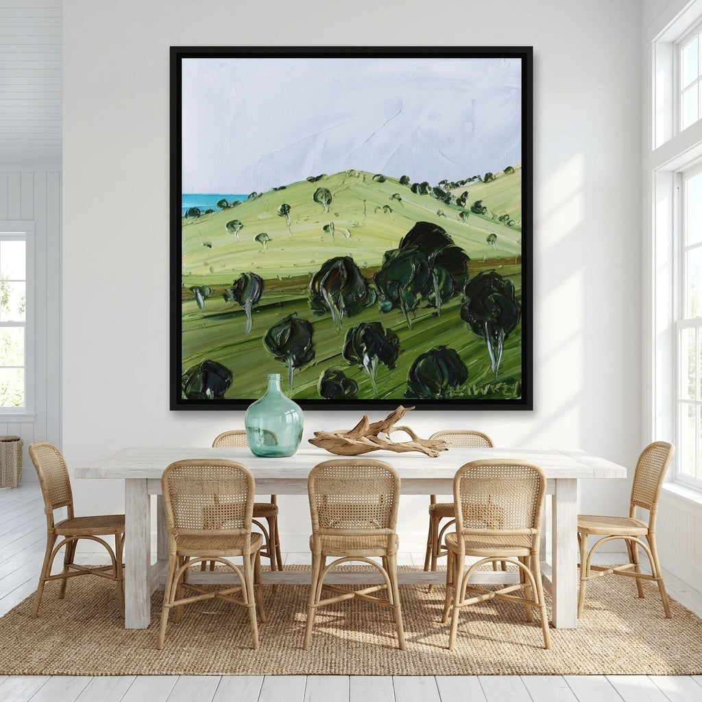 Oversized statement canvas wall art with a black surround styled on the wall in a coastal dining room