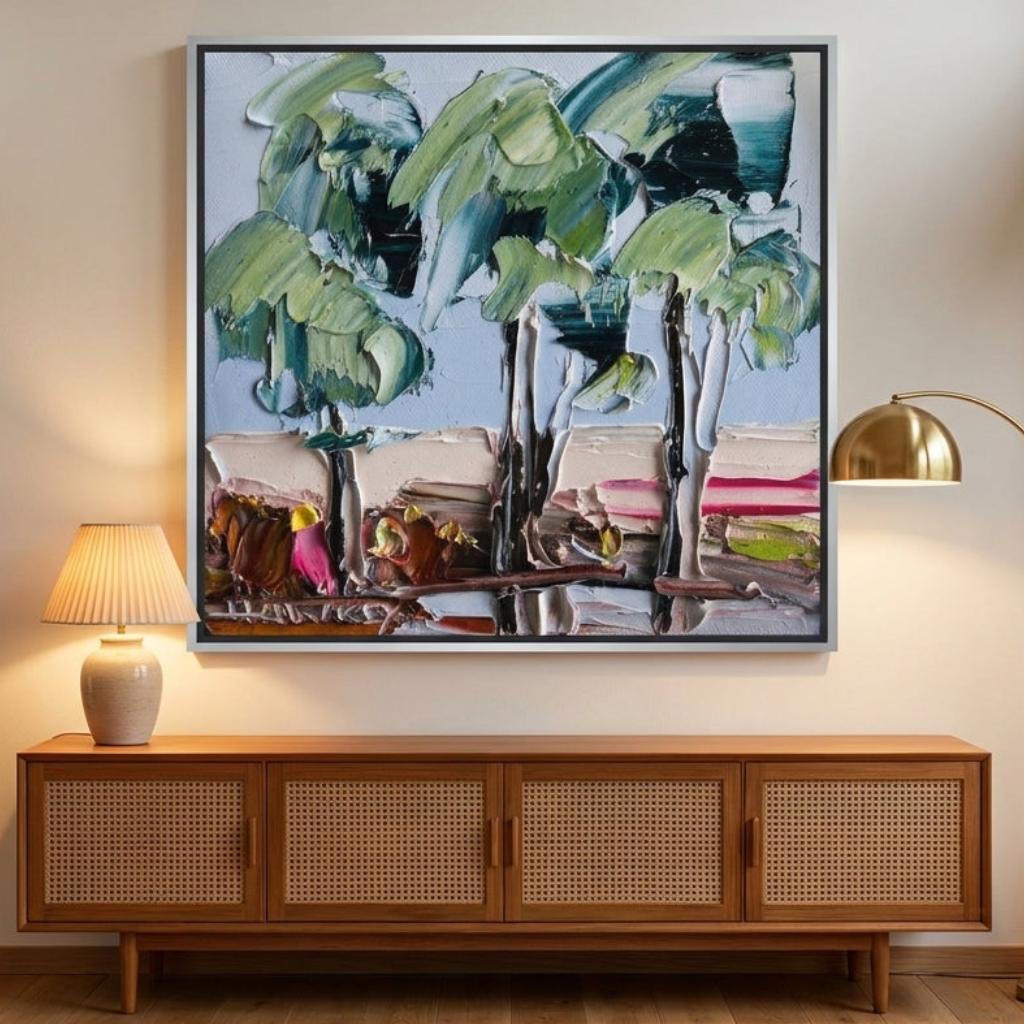 Oversized statement canvas wall art with a silver leaf surround styled on the wall in a mid-century living room