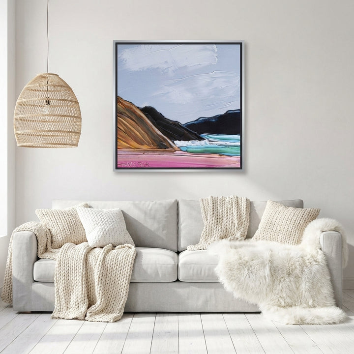 Canvas wall art with a silver leaf surround styled on the wall in a bright Scandinavian living room