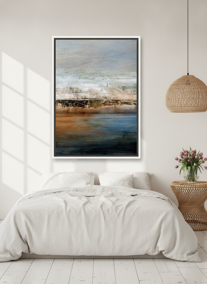 Canvas wall art with a white surround styled on the wall in a bright Scandinavian bedroom