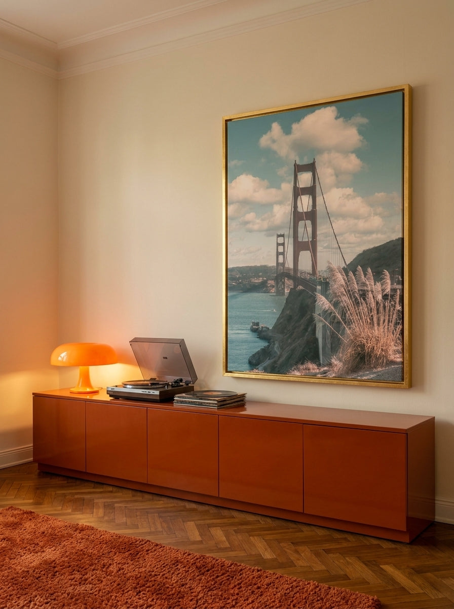 Oversized statement canvas wall art with a gold leaf surround styled on the wall in a retro 70s living room