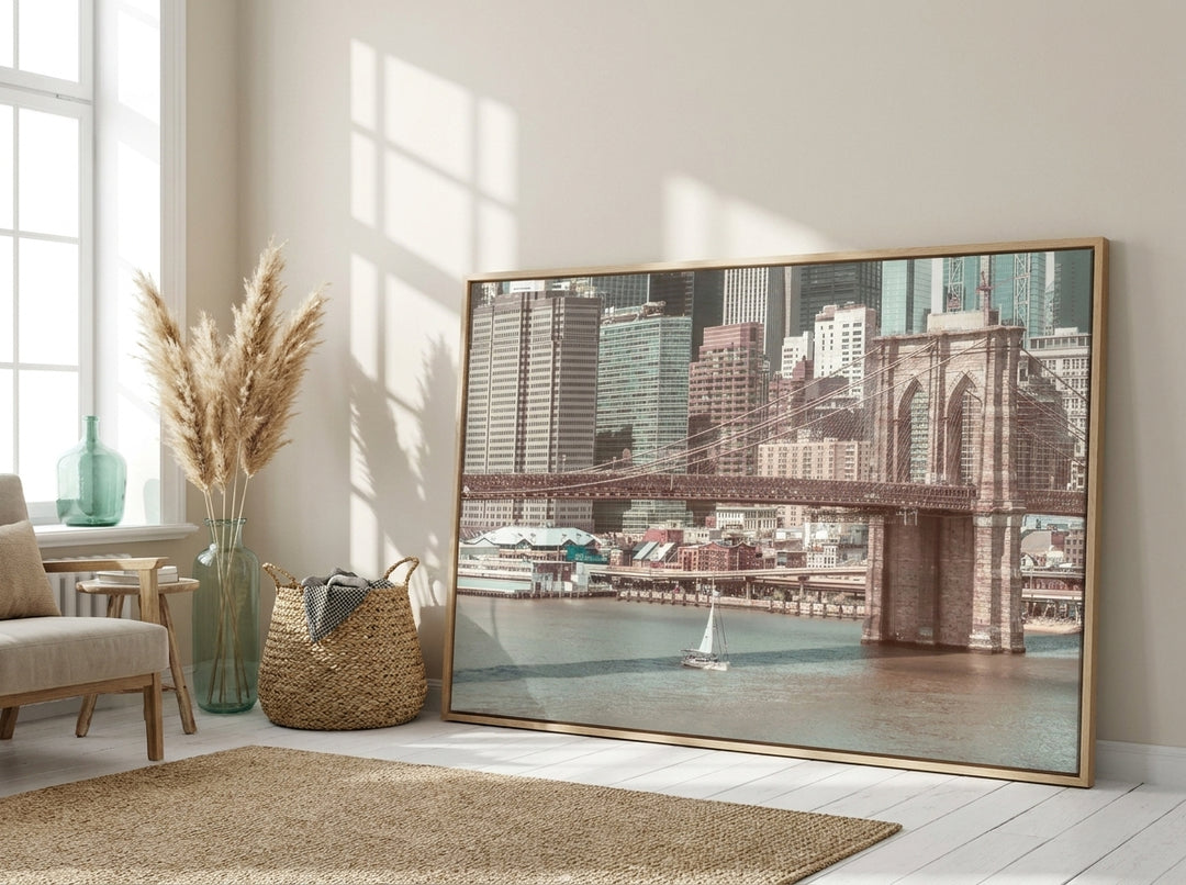 Oversized statement canvas wall art with a natural timber surround leaning against the wall in a coastal living room