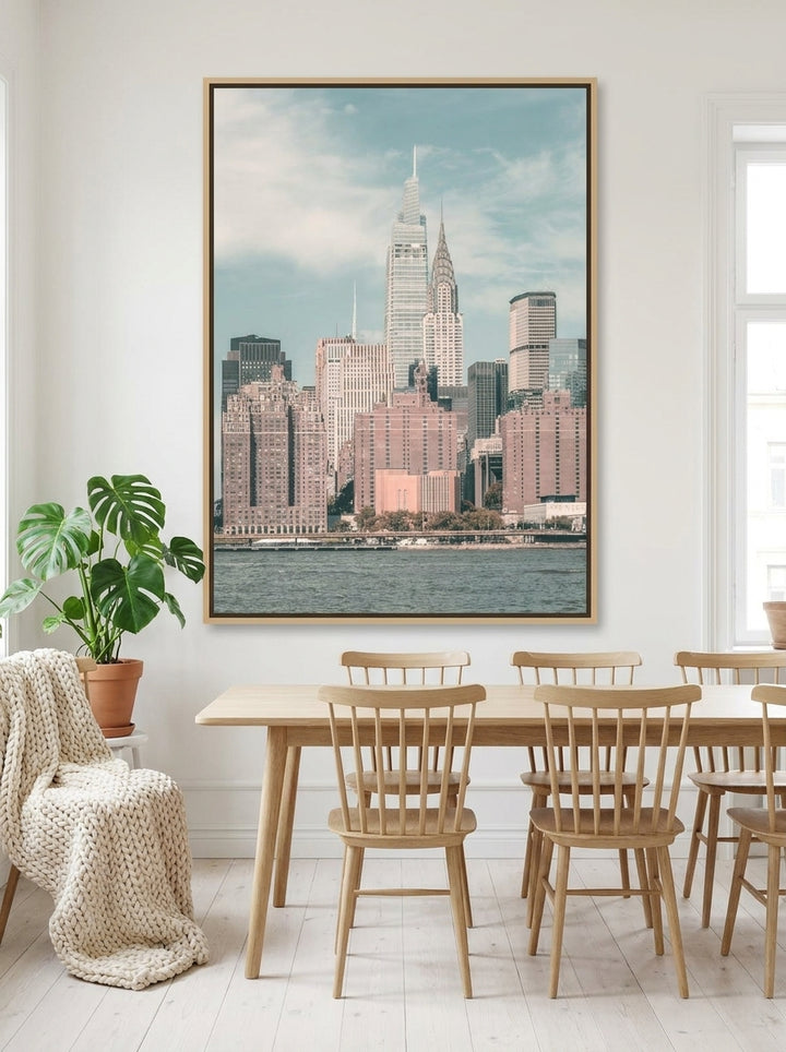 Oversized statement canvas wall art with a natural timber surround styled on the wall in a bright Scandinavian dining room
