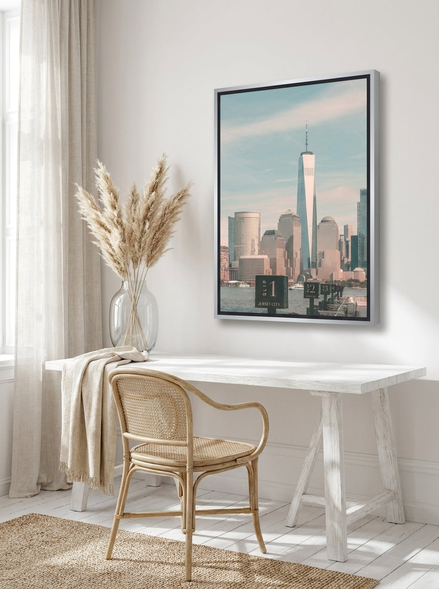Canvas wall art with a silver leaf surround styled on the wall in a coastal home office