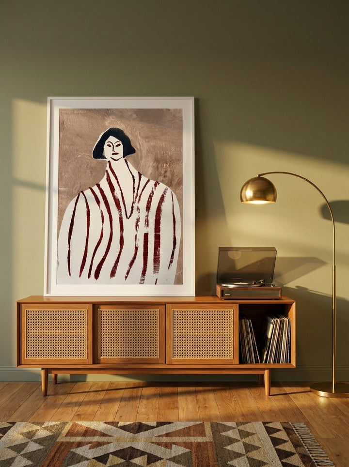 Modern wall art print standing on a sideboard in a mid-century home office