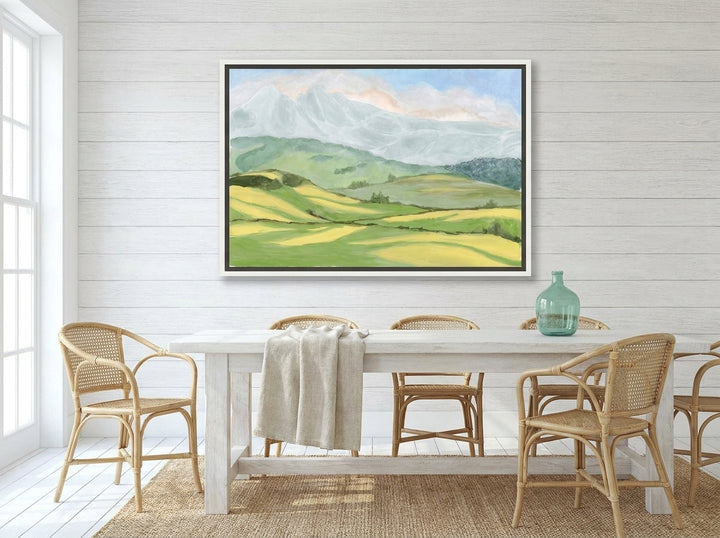 Canvas wall art with a white surround styled on the wall in a coastal dining room