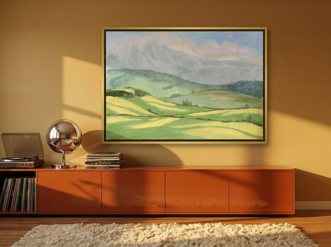 Oversized statement canvas wall art with a gold leaf surround styled on the wall in a retro 70s living room