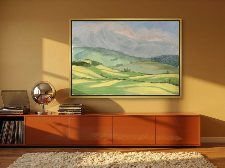 Oversized statement canvas wall art with a gold leaf surround styled on the wall in a retro 70s living room