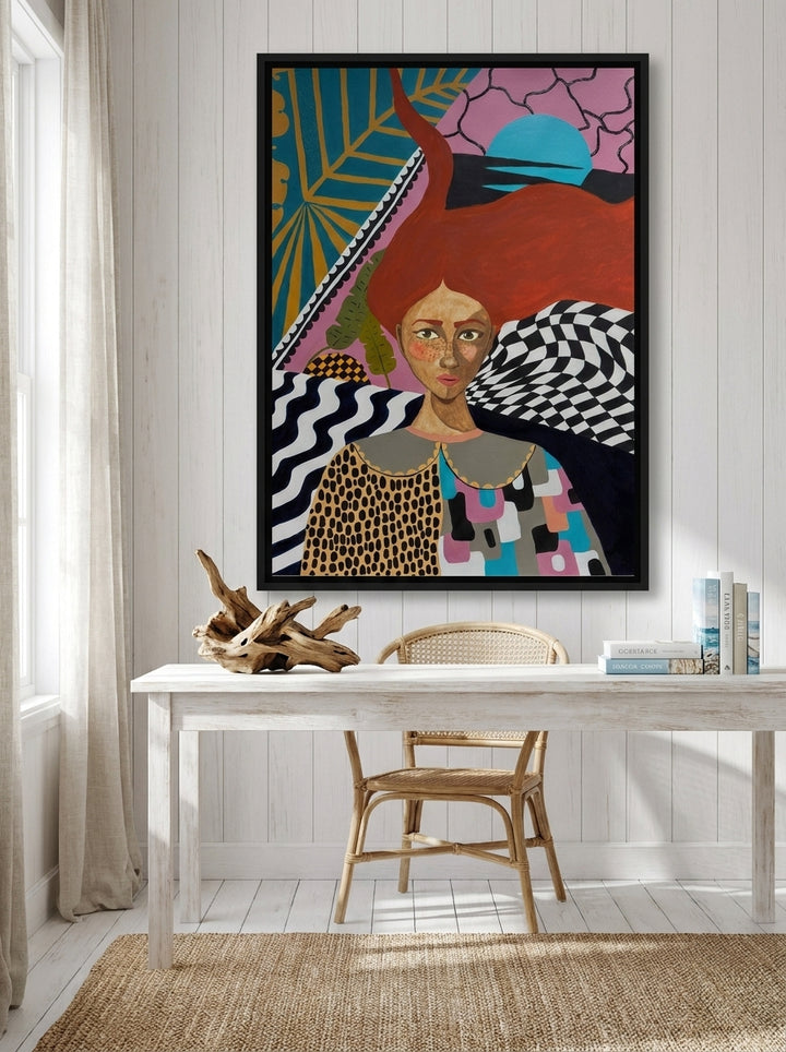 Canvas wall art with a black surround styled on the wall in a coastal home office