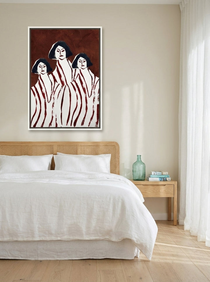 Canvas wall art with a white surround styled on the wall in a coastal bedroom