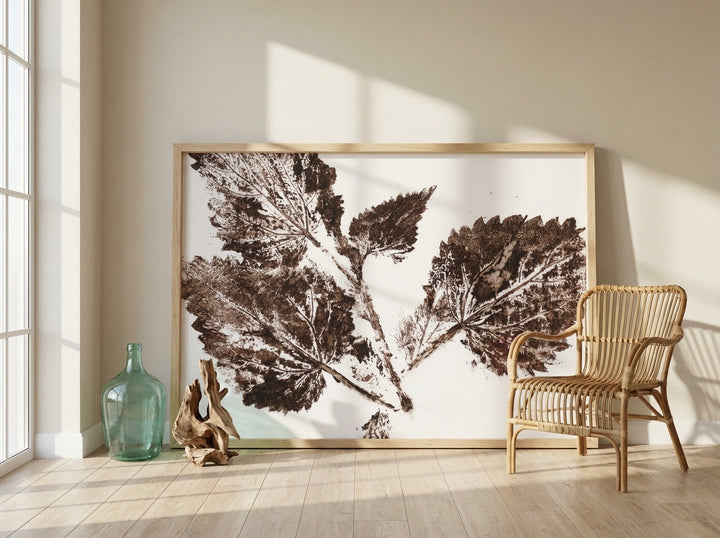 Oversized statement modern wall art print leaning against the wall in a coastal dining room