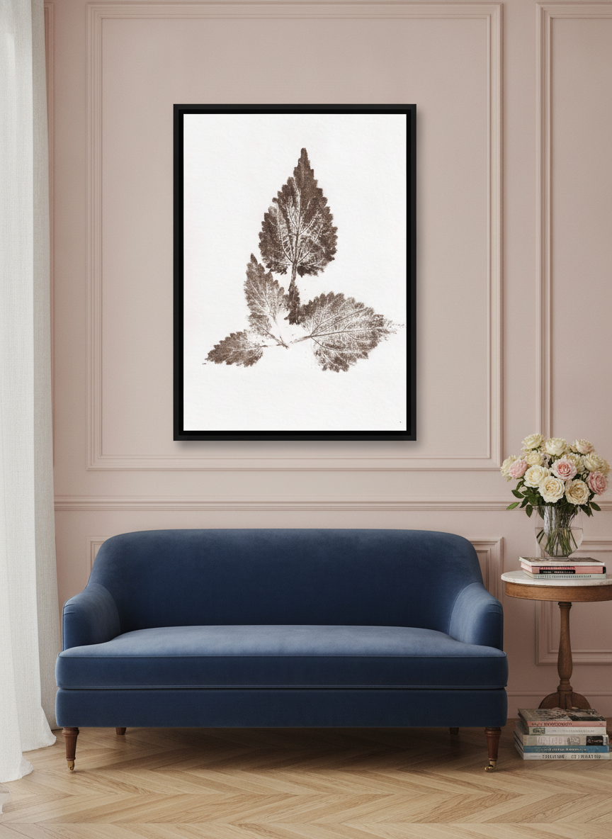 Canvas wall art with a black surround styled on the wall in a Parisian living room
