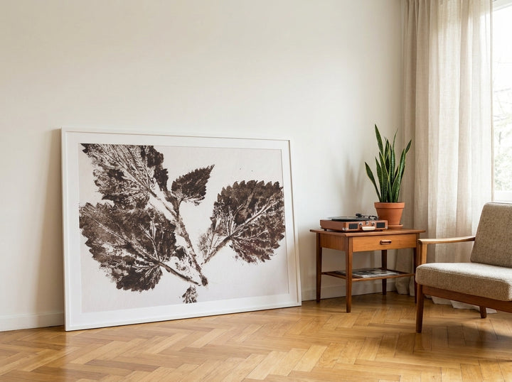Oversized statement modern wall art print leaning against the wall in a mid-century living room