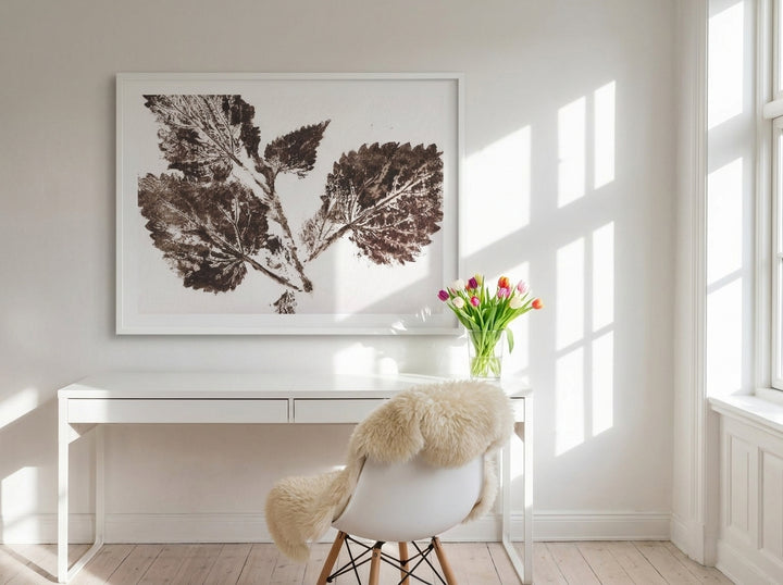 Modern wall art print styled on the wall in a bright Scandinavian home office