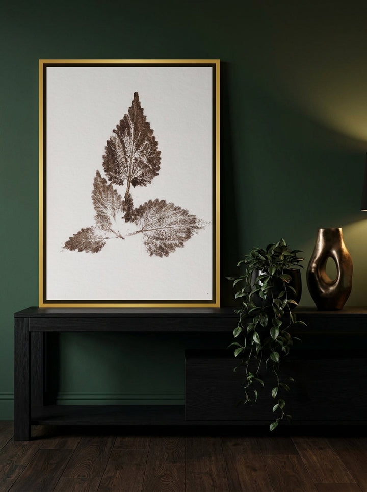 Canvas wall art with a gold leaf surround standing on a console in a moody home office