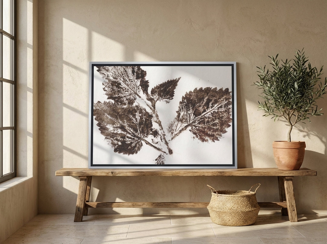 Canvas wall art with a silver leaf surround standing on a bench in a Mediterranean bedroom