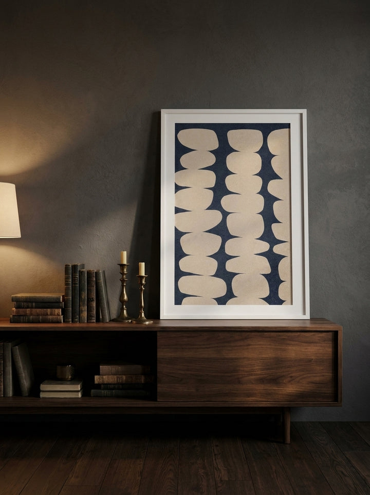 Modern wall art print standing on a sideboard in a moody living room