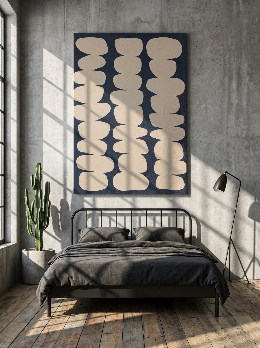 Stretched canvas wall art styled on the wall in an industrial loft bedroom
