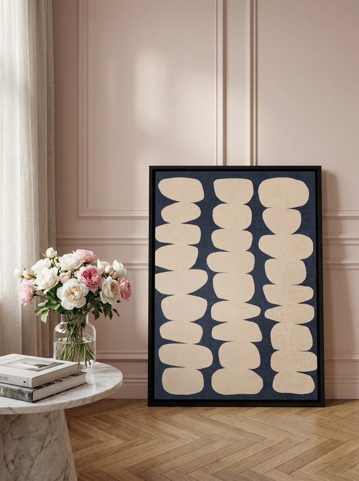 Canvas wall art with a black surround leaning against the wall in a Parisian bathroom