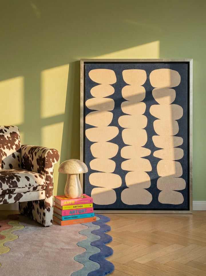 Canvas wall art with a silver leaf surround leaning against the wall in a colourful eclectic bedroom