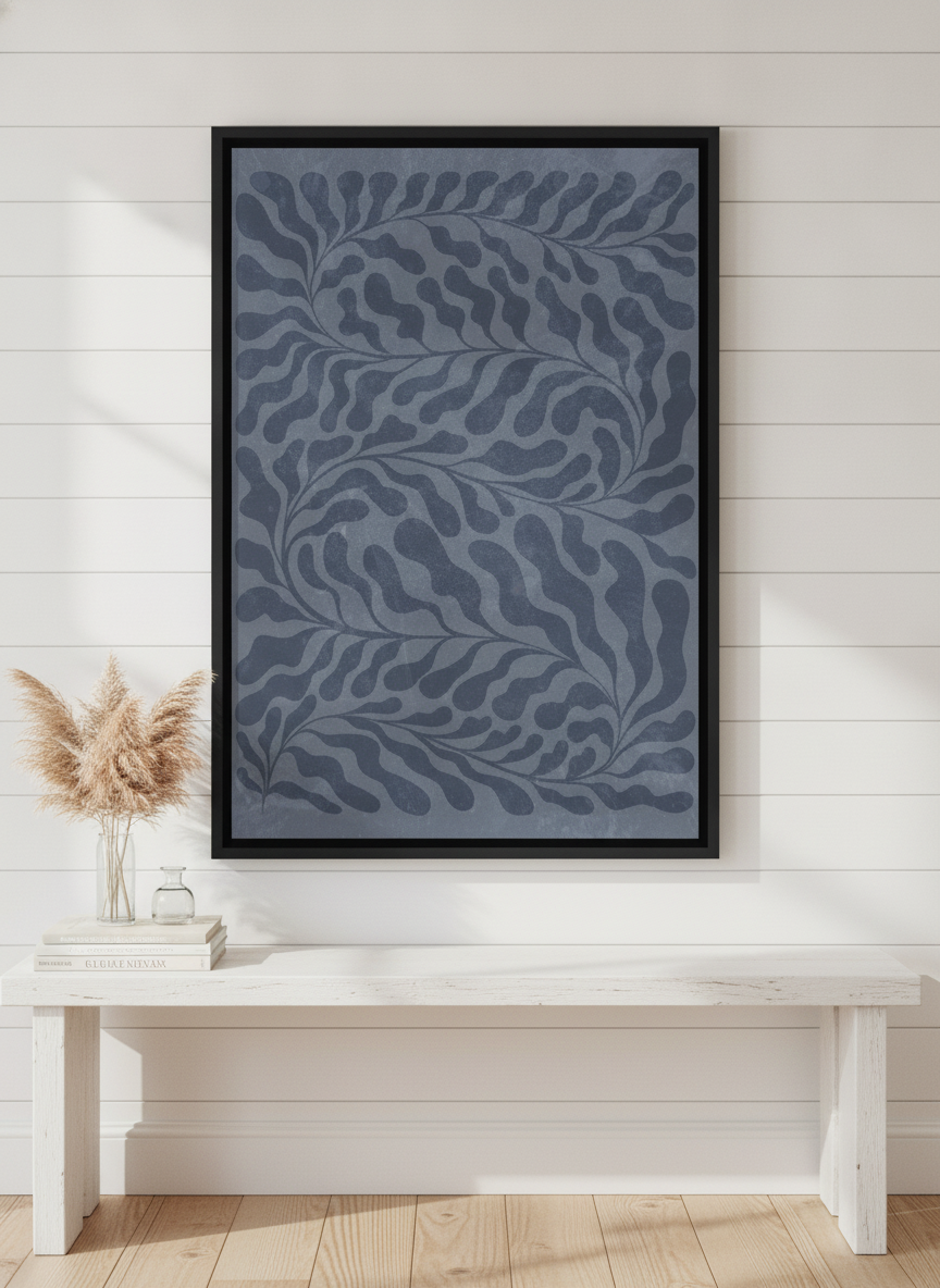 Canvas wall art with a black surround standing on a console in a coastal home office