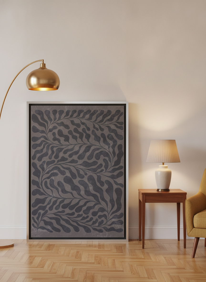 Canvas wall art with a silver leaf surround leaning against the wall in a mid-century home office