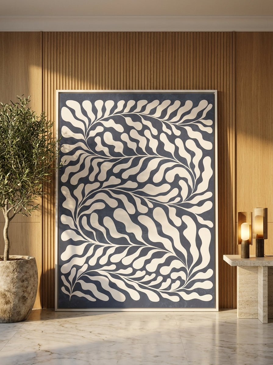 Oversized statement canvas wall art with a white surround leaning against the wall in a luxe living room