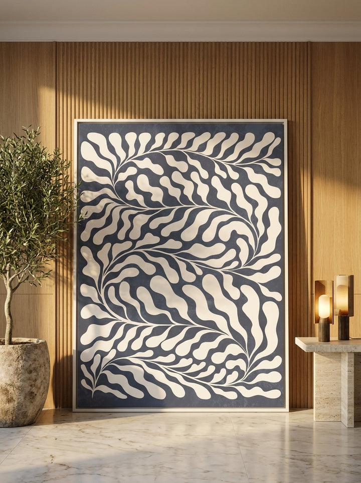 Oversized statement canvas wall art with a white surround leaning against the wall in a luxe living room