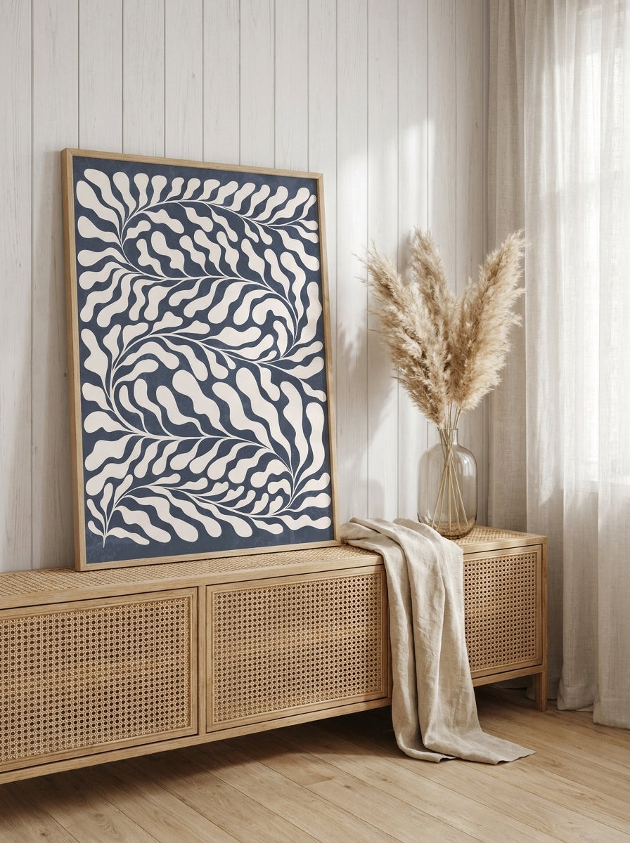 Modern wall art print standing on a sideboard in a coastal home office