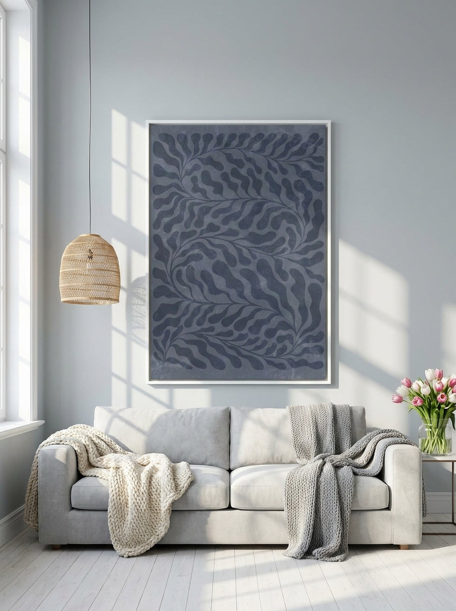 Oversized statement canvas wall art with a white surround styled on the wall in a bright Scandinavian living room