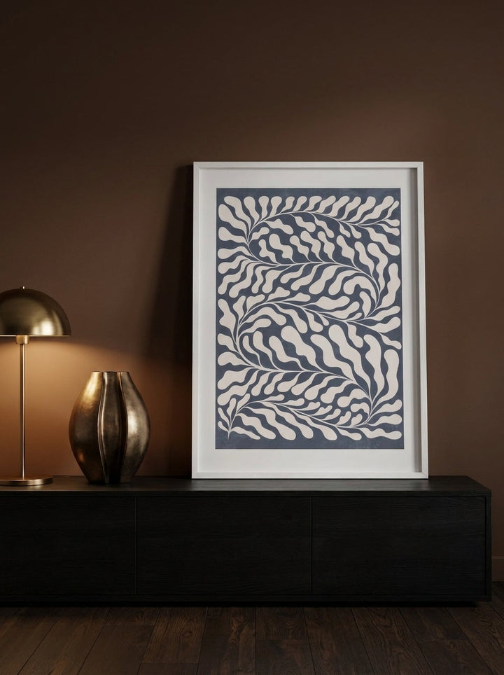 Modern wall art print standing on a console in a moody living room