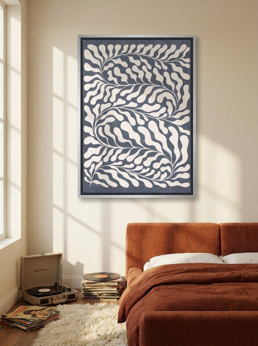 Canvas wall art with a silver leaf surround styled on the wall in a retro 70s bedroom