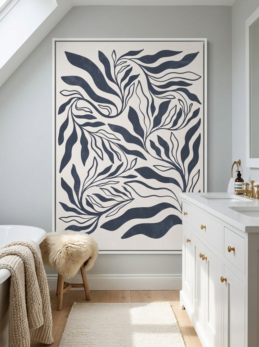 Canvas wall art with a white surround styled on the wall in a bright Scandinavian bathroom