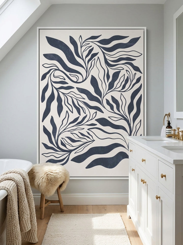 Canvas wall art with a white surround styled on the wall in a bright Scandinavian bathroom