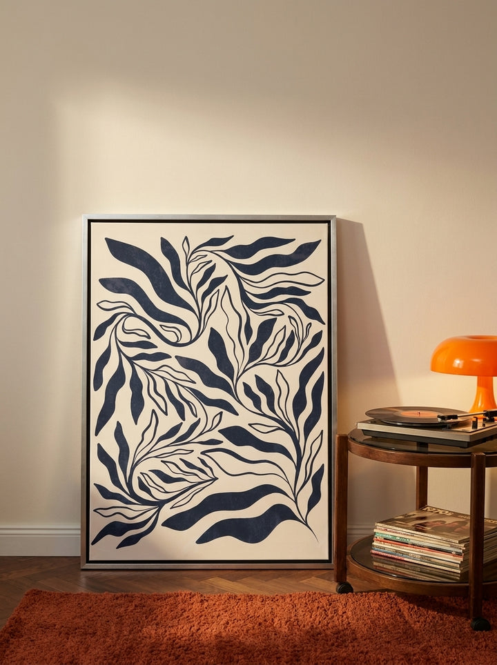Canvas wall art with a silver leaf surround leaning against the wall in a retro 70s bedroom