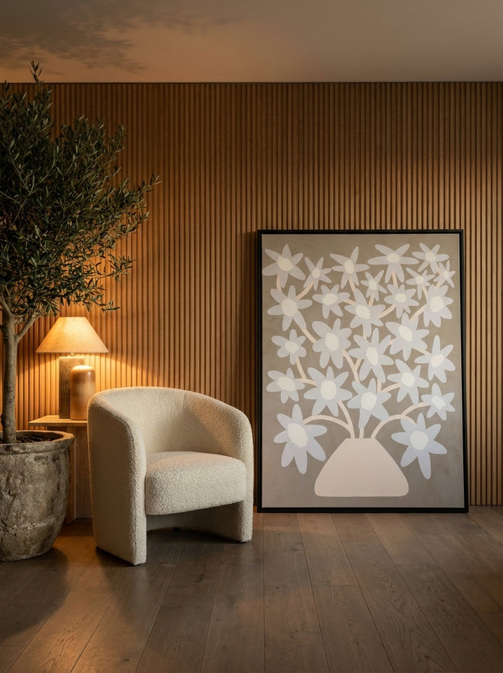 Canvas wall art with a black surround leaning against the wall in a luxe dining room