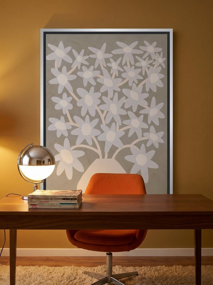 Canvas wall art with a silver leaf surround styled on the wall in a retro 70s home office
