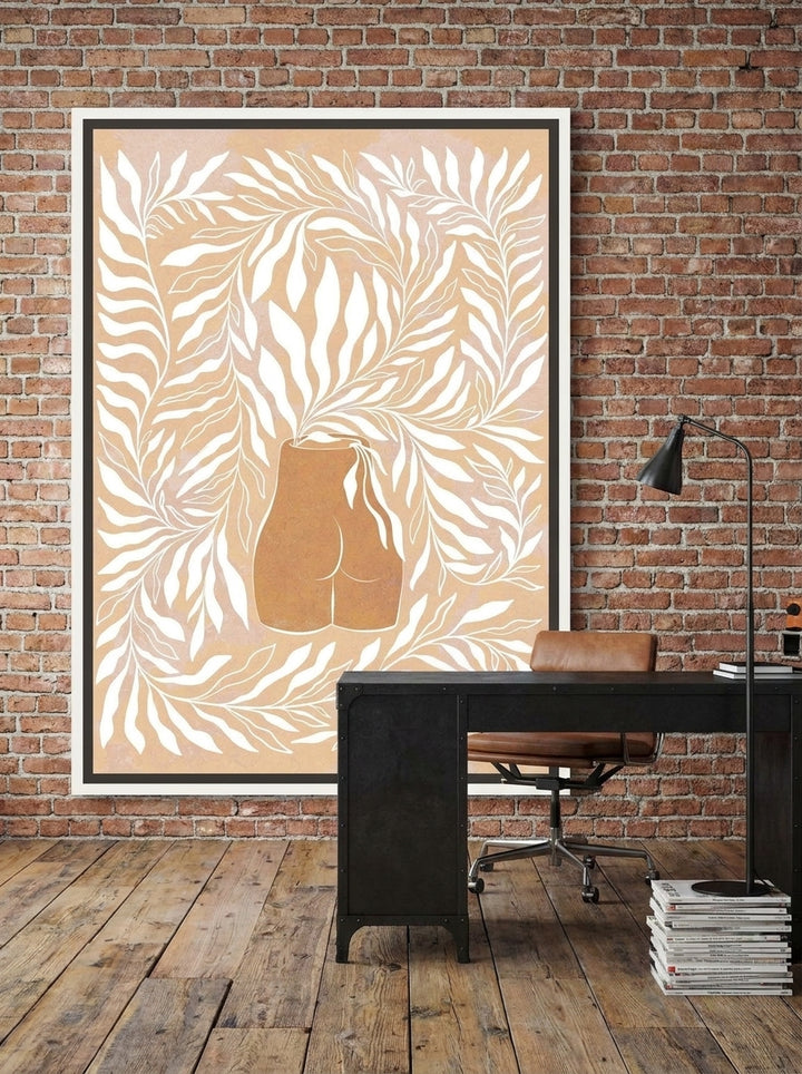 Canvas wall art with a white surround styled on the wall in an industrial loft home office